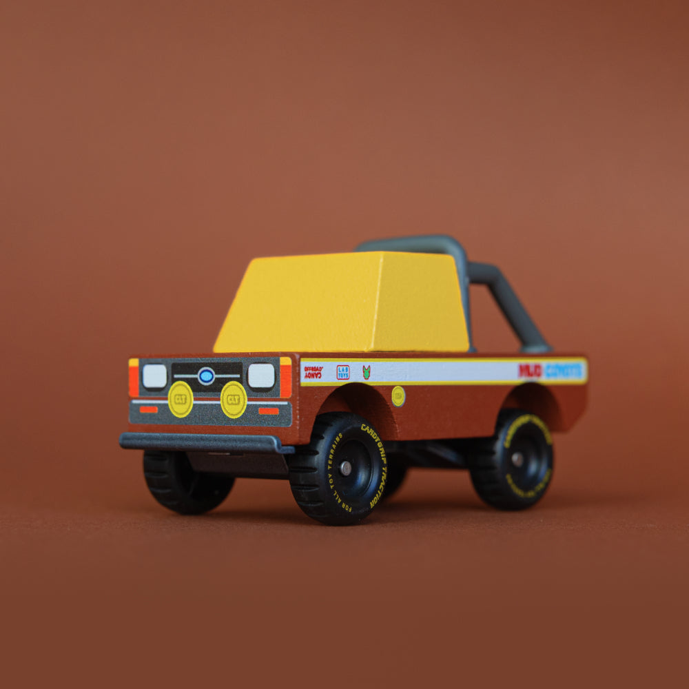 Quarter front angle of Mud Coyote Toon car against brown background