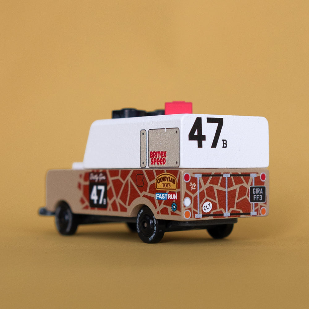 Quarter back angle of Safari Gira Toon car against beige background